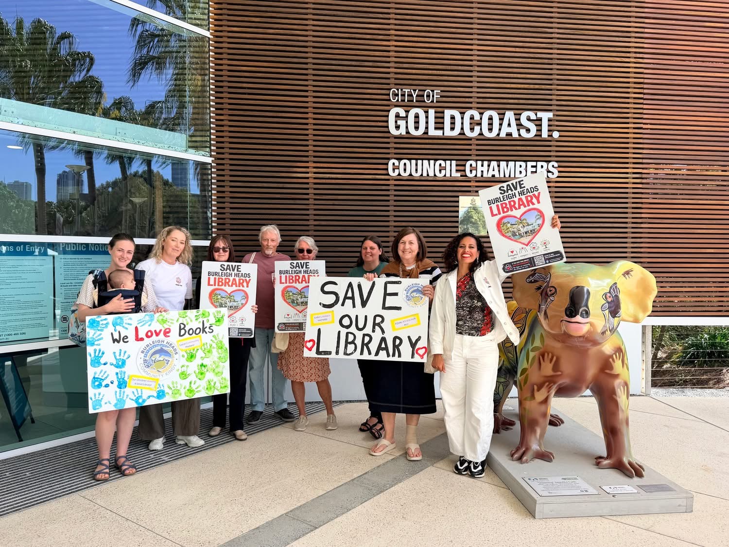 Campaigners holding 'Save Burleigh Heads Library' signs outside Gold Coast City Council Chambers